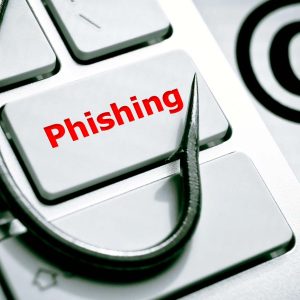 Tangentbord med texten "Phishing" med en fiskekrok och ett @-tecken intill.