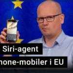 Karl Emil Nikka håller upp en Iphone som visar nya Siri-appen. I bakgrunden syns EU:s flagga.